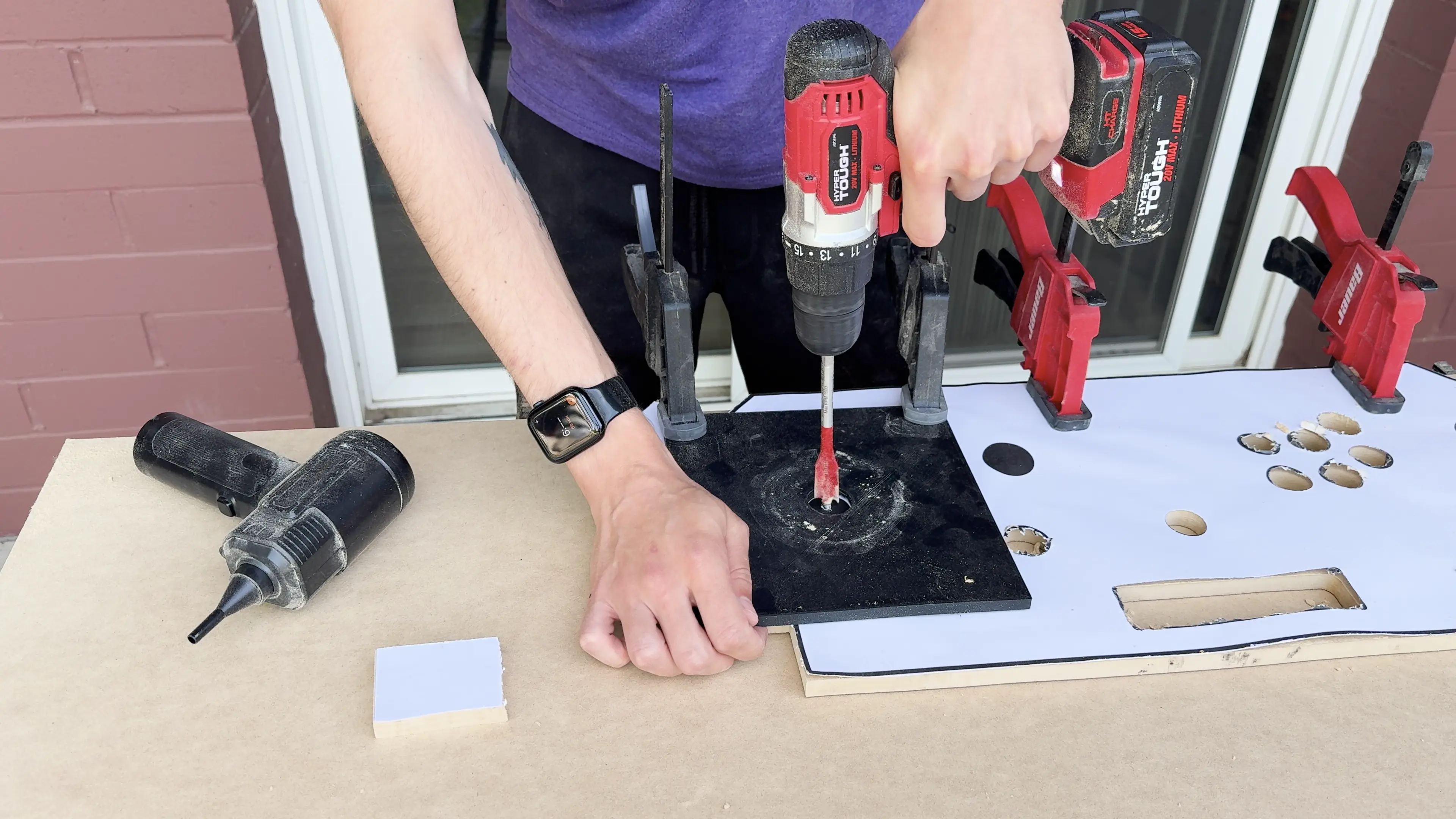 Using a spade bit to drill a very large pilot hole for the router.