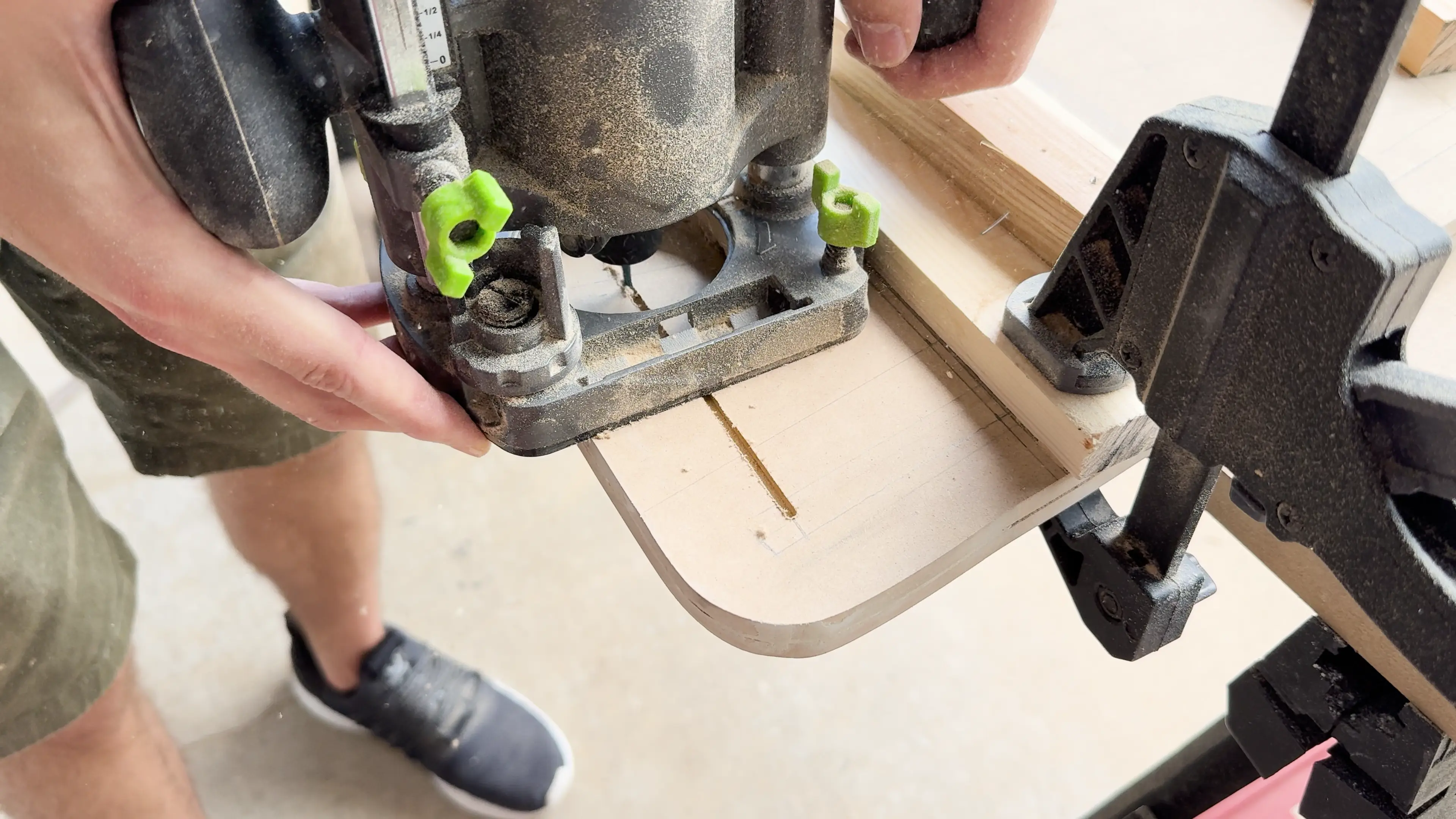 Using the router with a plunge base and a spiral upcut bit to cut grooves for the marquee.