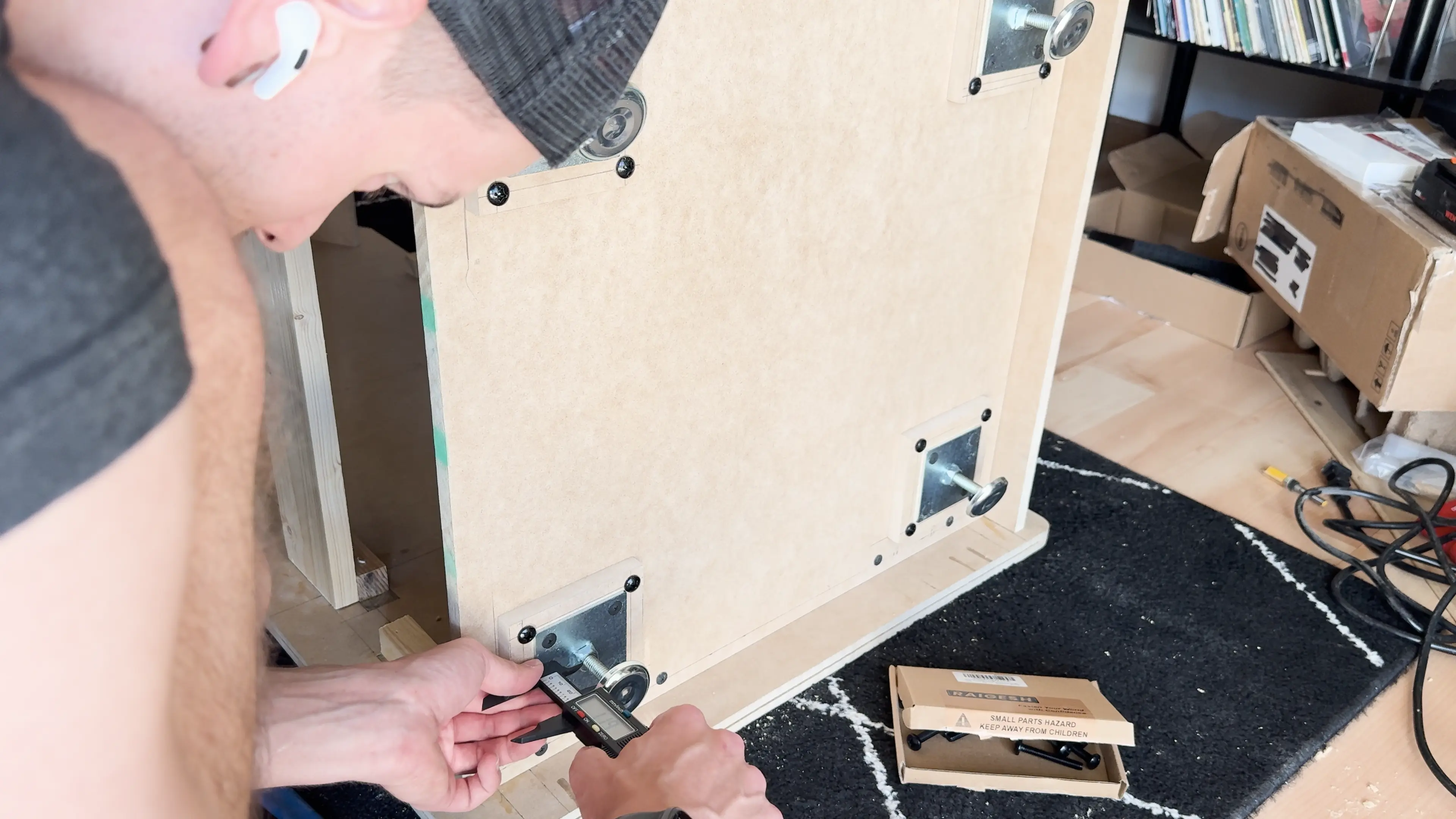 Measuring the height of the adjustable feet on the bottom panel.