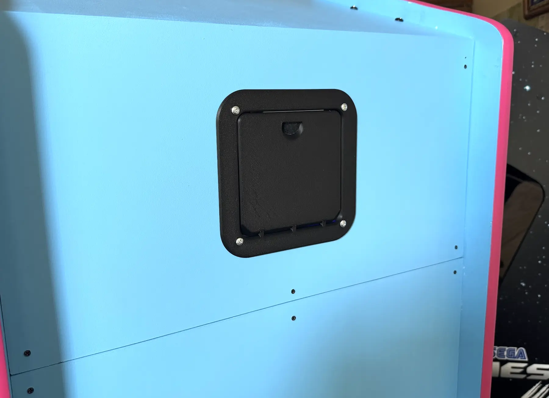 The 3D printed rear access door closes with magnets.