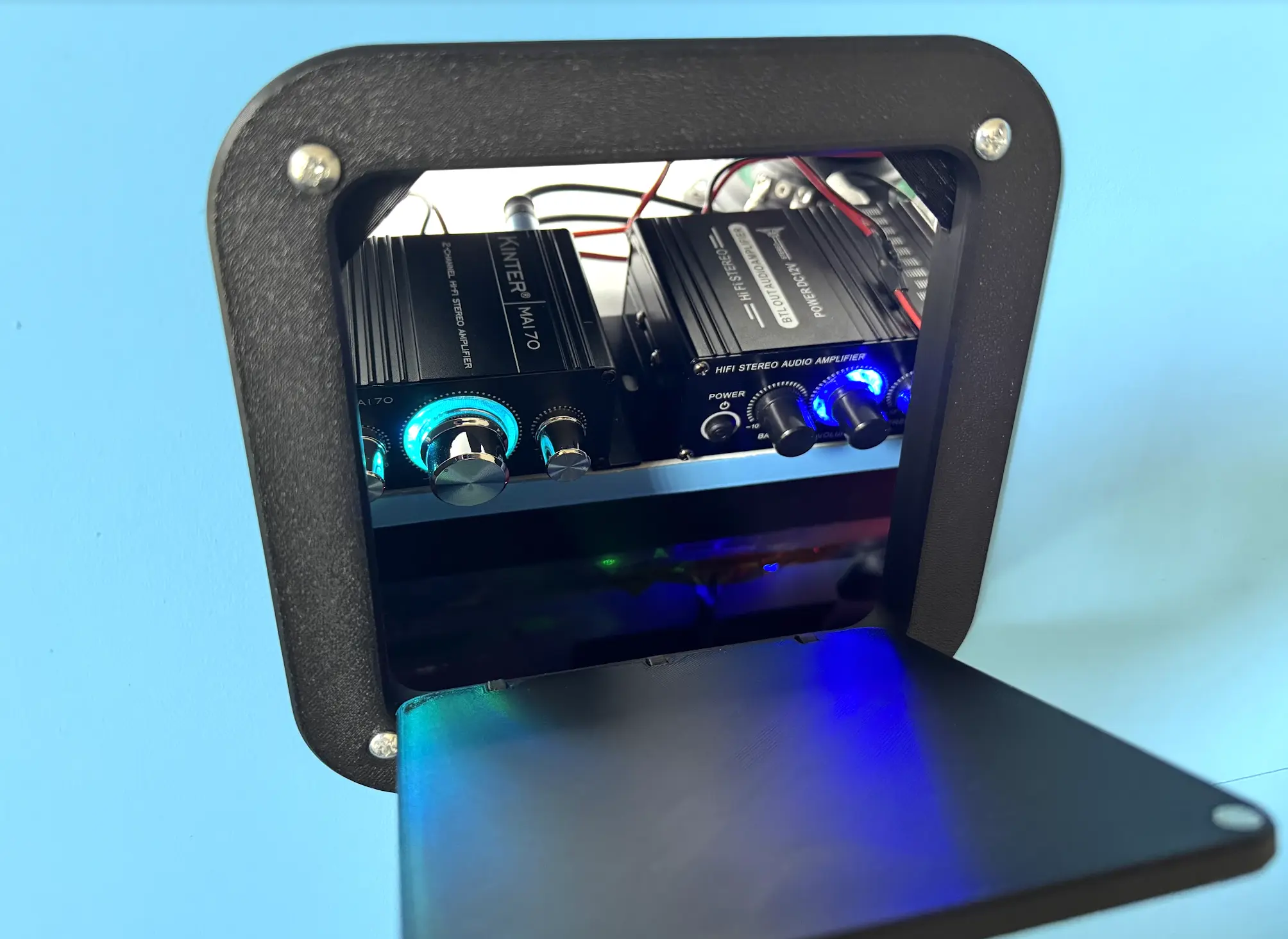 The 3D printed rear access door closes with magnets.